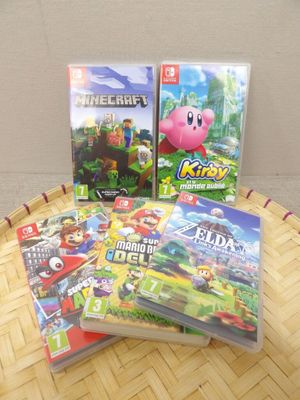 three nintendo wii games sitting on top of a wooden table