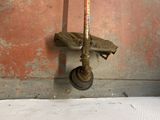 a rusted fire hydrant hanging from the side of a wall