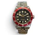 an image of a red and black watch on a white surface