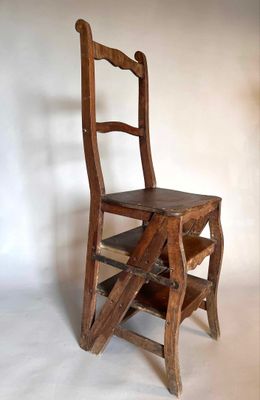 a wooden chair that has a ladder on it