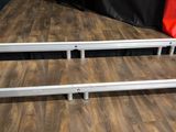 a metal bed frame that is sitting on a wooden floor