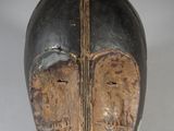 an image of a wooden mask with a cross on it
