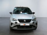 the front view of a silver car in a white room
