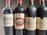 several bottles of wine are lined up in a row on a table