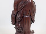statue of a man in a robe with a bird on his shoulder