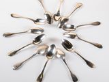 a lot of spoons arranged in a circle on the table