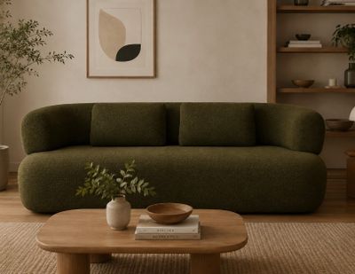 un canapé vert au milieu d'un salon
