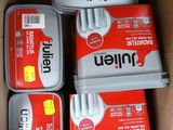 four tins of tinned food sitting in a cardboard box