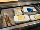 two containers of food sitting in a drawer in a kitchen