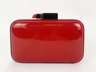 a red purse with a pencil sticking out of it