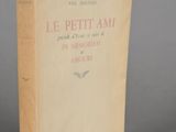 an old book sitting on top of a table on a gray surface