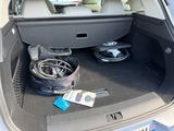 a trunk of a car with a bunch of electronics in it