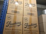 several boxes of cigarettes are stacked on a pallet in a warehouse