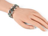 an image of a woman ' s hand with a bracelet on it