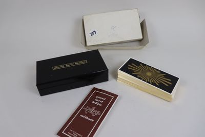 three match cards are sitting on a table next to a box of matches