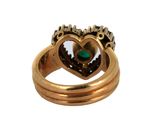 a gold ring with a green stone in the middle