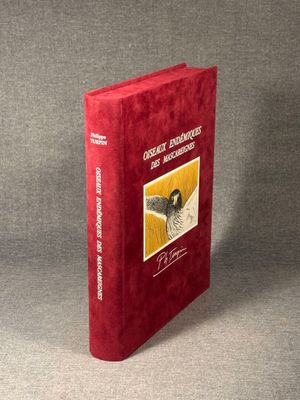 an image of a red book with a picture of a bird on it