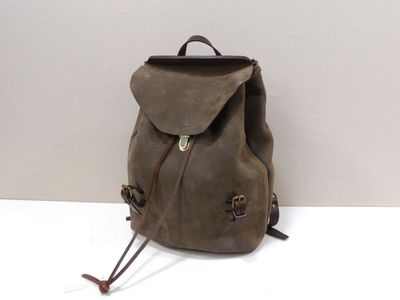 brown waxed canvas backpack with leather straps and buckles