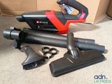 a black and red corded vacuum and a black and red brush