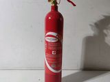a red fire extinguisor sitting on a white surface