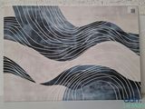 reproduction d'un tableau représentant des vagues sur un mur à fond blanc
