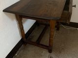 a wooden table with a drawer underneath it in a room
