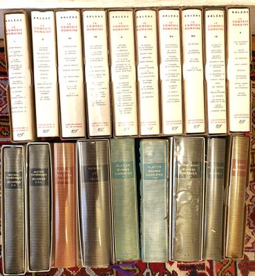 a lot of books that are sitting on a rug