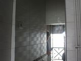 a woman standing in a bathroom looking at her reflection in the mirror