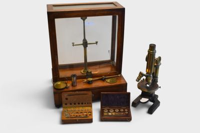 a miniature microscope and other items in a display case