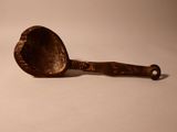 a spoon that is sitting on a white surface
