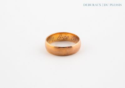 a close up of a gold ring with writing on it