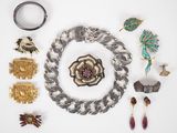 many different pieces of jewelry laid out on a white surface