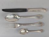 five spoons, a knife, and a fork on a table