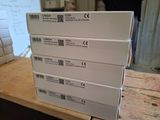 several white boxes stacked on top of each other on top of a wooden table