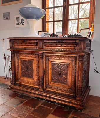 a large wooden cabinet in the middle of a room
