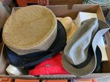 a cardboard box filled with hats and other items