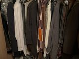 a closet with a lot of clothes hanging on it