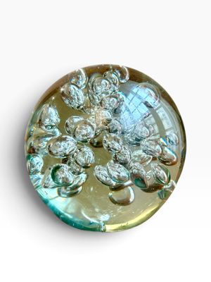 a picture of a glass button with a flower design on it