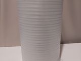 a white vase that is sitting on a table