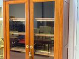 a wooden cabinet with glass doors in a room