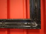 a picture of a picture frame hanging on a red wall