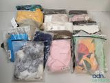 many different types of clothing in bags on the table