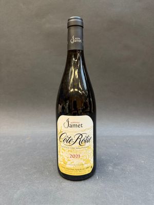 an empty bottle of wine sitting on a table