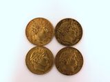 three gold coins with a portrait of a man and a woman on them