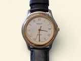 a silver and black watch with roman numerals on it