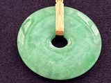 green jade donut pendant with a gold plated bail