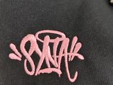 black hoodie with a pink logo on the front