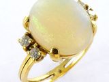 an oplite and diamond ring set in yellow gold