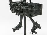 an image of a black sculpture of a bird on a stand