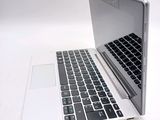 a white laptop with a black keyboard on a white surface